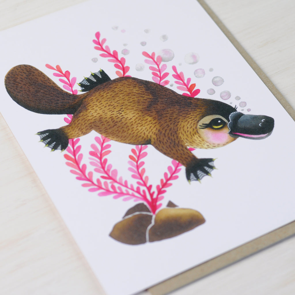Greeting card featuring a cute swimming platypus