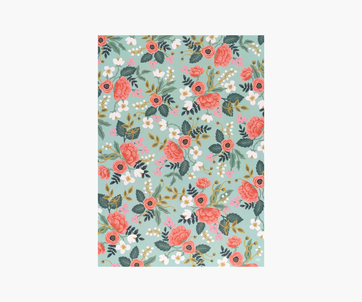 A single sheet of wrapping paper, featuring a full colour floral design of red roses, white flowers and leaves on a mint green background