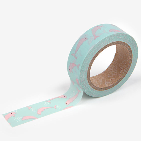 A roll of Daily Like washi tape, featuring pink dolphins on a light blue background