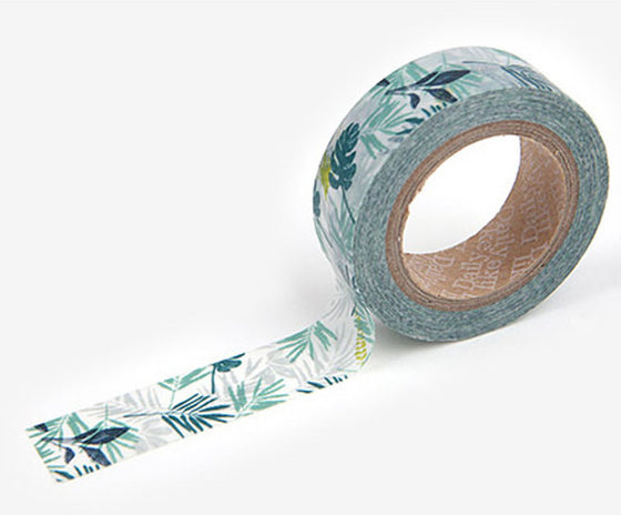 A roll of Daily Like washi tape, featuring green and blue tropical leaves on a white background