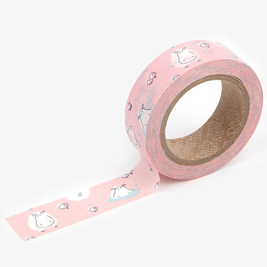 A roll of Daily Like washi tape, featuring white hippos on a blush pink background