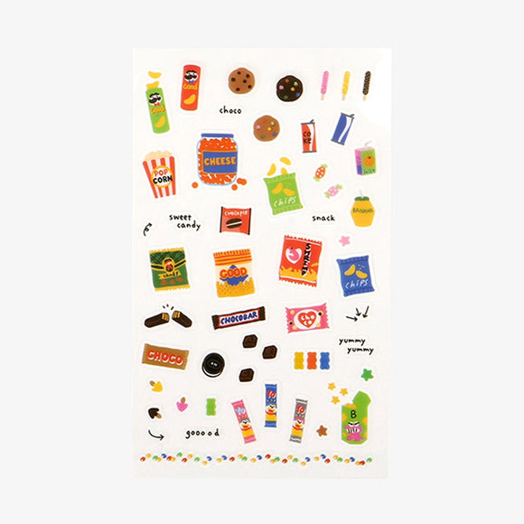 A sheet of Daily Like stickers featuring snacks like chips, chocolate bars, candy, and biscuits