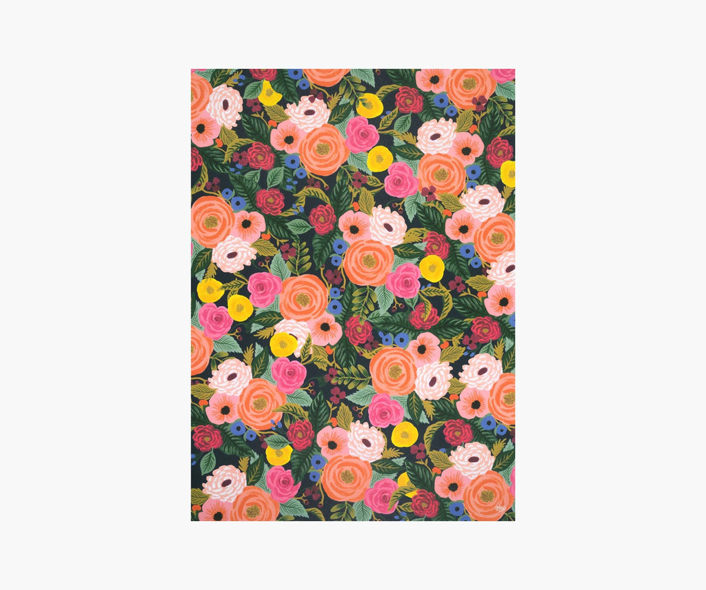 A single sheet of wrapping paper featuring the Juliet Rose design by Rifle Paper Co. This design features bouquets of pink and yellow roses surrounded by foliage on a black background.
