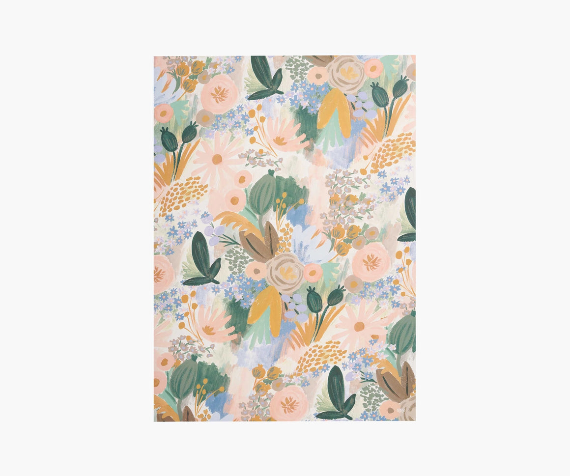 A single sheet of Luisa gift wrap by Rifle Paper Co, featuring soft painterly florals in pale pink, green, and mustard tones.